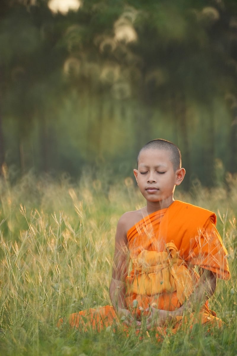 Person practicing yoga by the beach